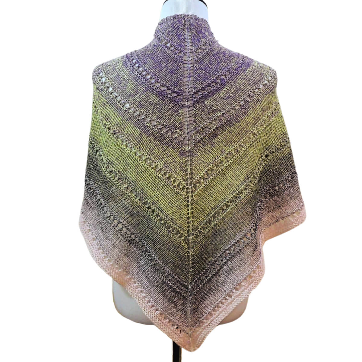 Back of the torso of a dress form wearing a triangular knitted shawl in stockinette stitch with a stripe of eyelet stitches every few inches, and changing colors slowly from gray to green to gray to pink. The point of the shawl hangs in the front and the sides are draped over the shoulders.